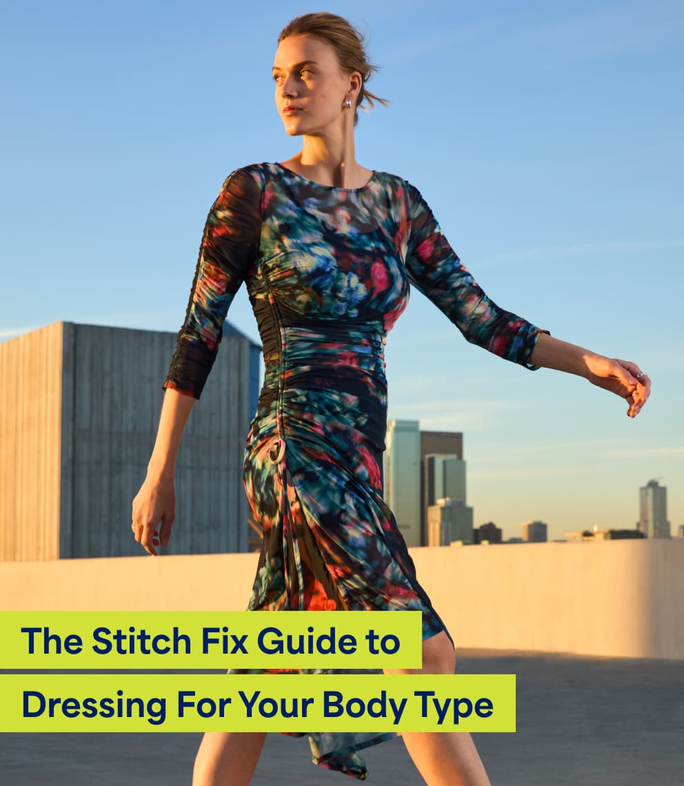 “Dressing For Your Body Type”   Model wearing Stitch Fix women’s clothing, including: a fitted long-sleeve midi dress with a bold multicolor abstract print, standing on a rooftop with city buildings in the background. Text on image reads: “The Stitch Fix Guide to Dressing For Your Body Type.”