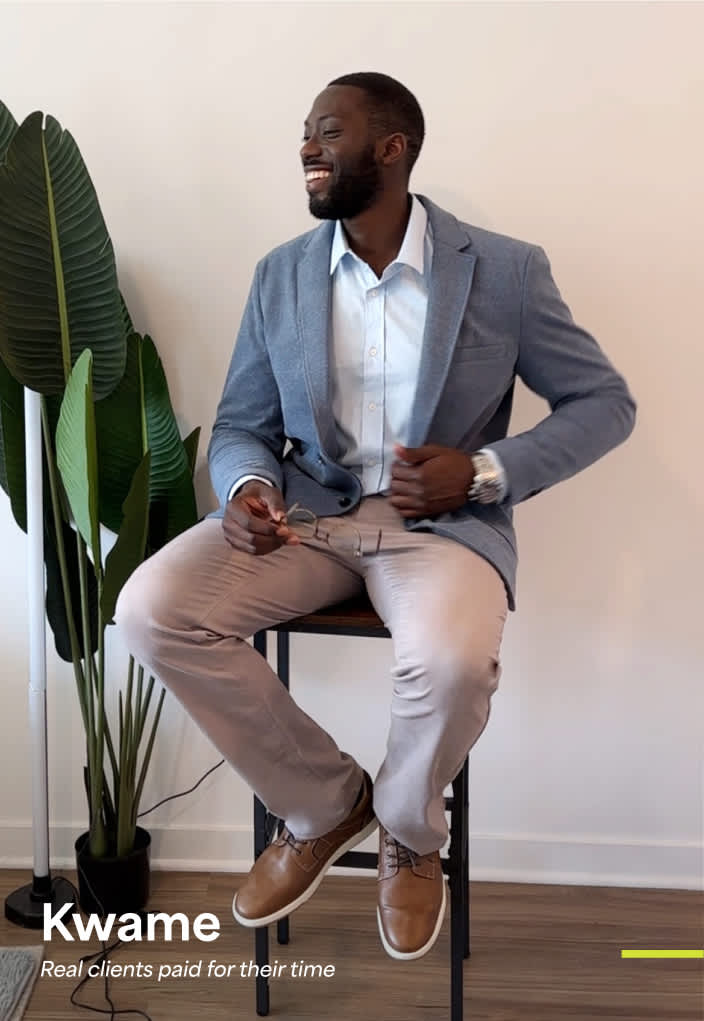 Model wearing Stitch Fix men’s clothing, including: light blue blazer, white shirt, beige pants, tan shoes.