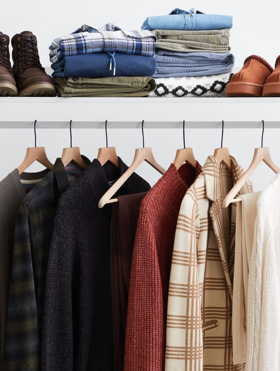 Model wearing Stitch Fix women’s clothes including colorful jacket and black pants. 
