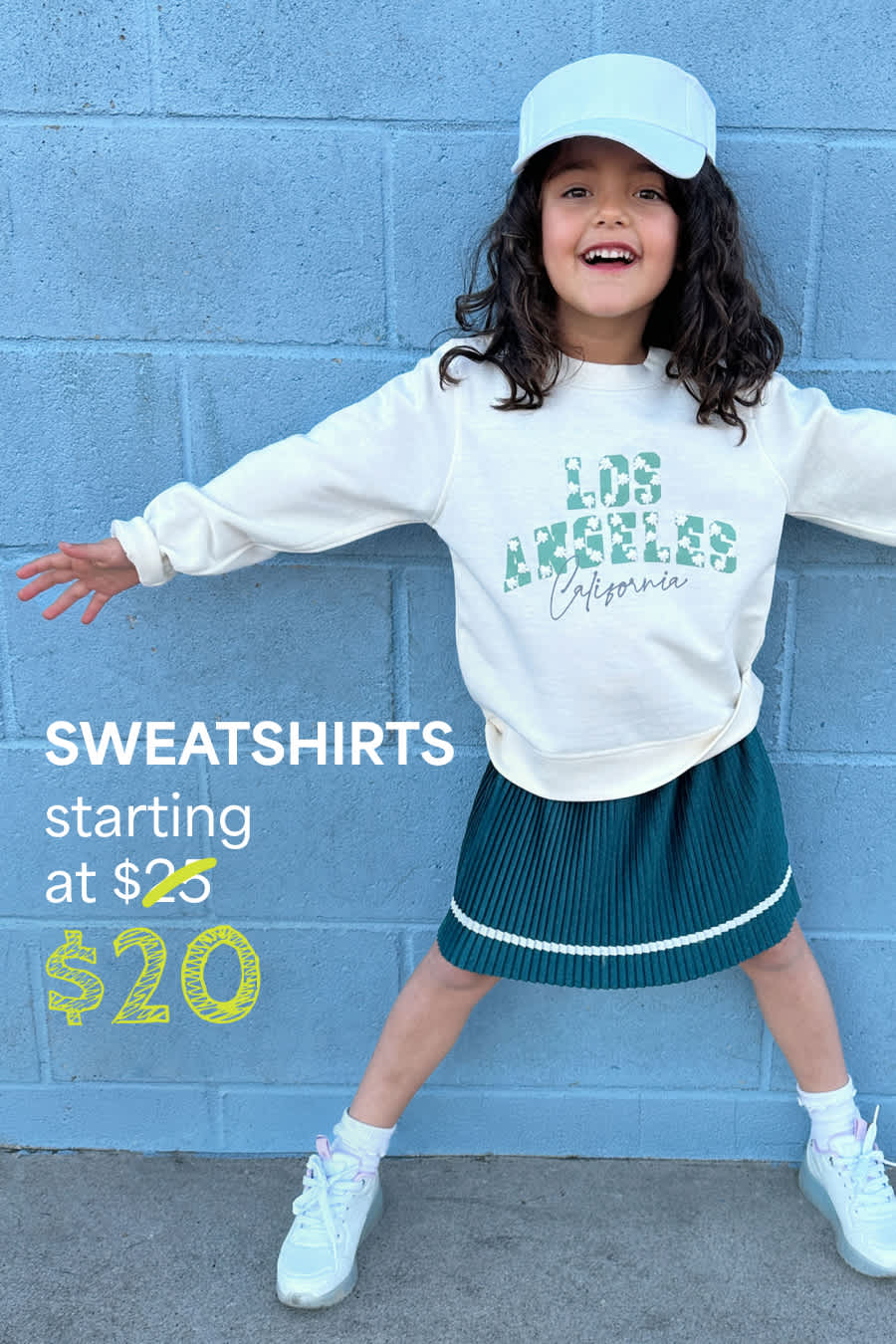 Girl in Stitch Fix: white sweatshirt, teal skirt, blue socks, smiling. Text: “SWEATSHIRTS starting at $20.”