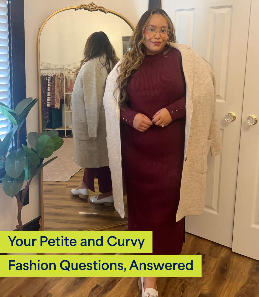 Your Petite and Curvy Fashion Questions, Answered. A woman with long hair and glasses wears a burgundy knit maxi dress and cream loafers with a long, cream jacket over her shoulders.