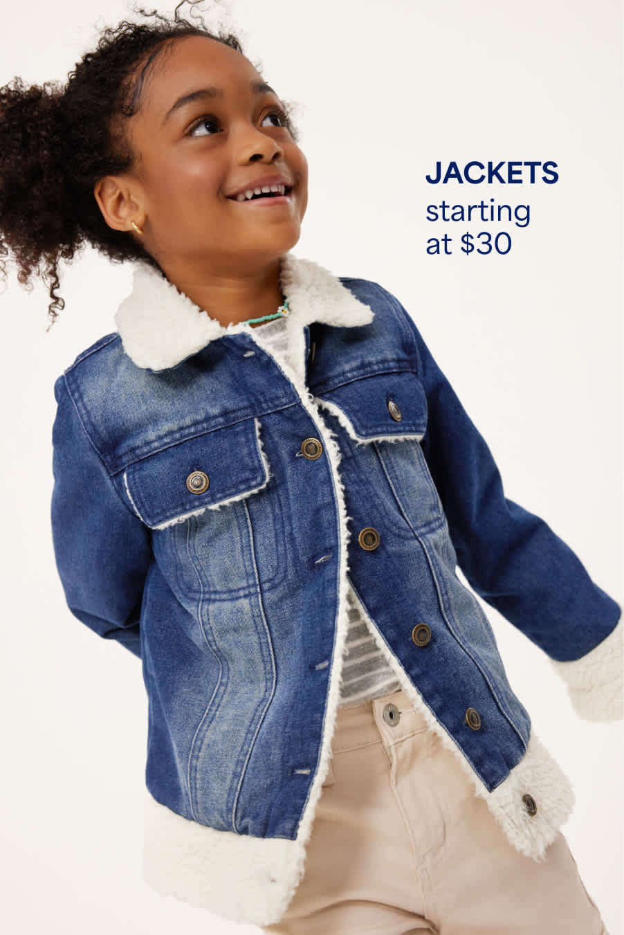 A girl wears a fleece-lined denim jacket, a striped tee and stone-colored pants. Jackets starting at $30