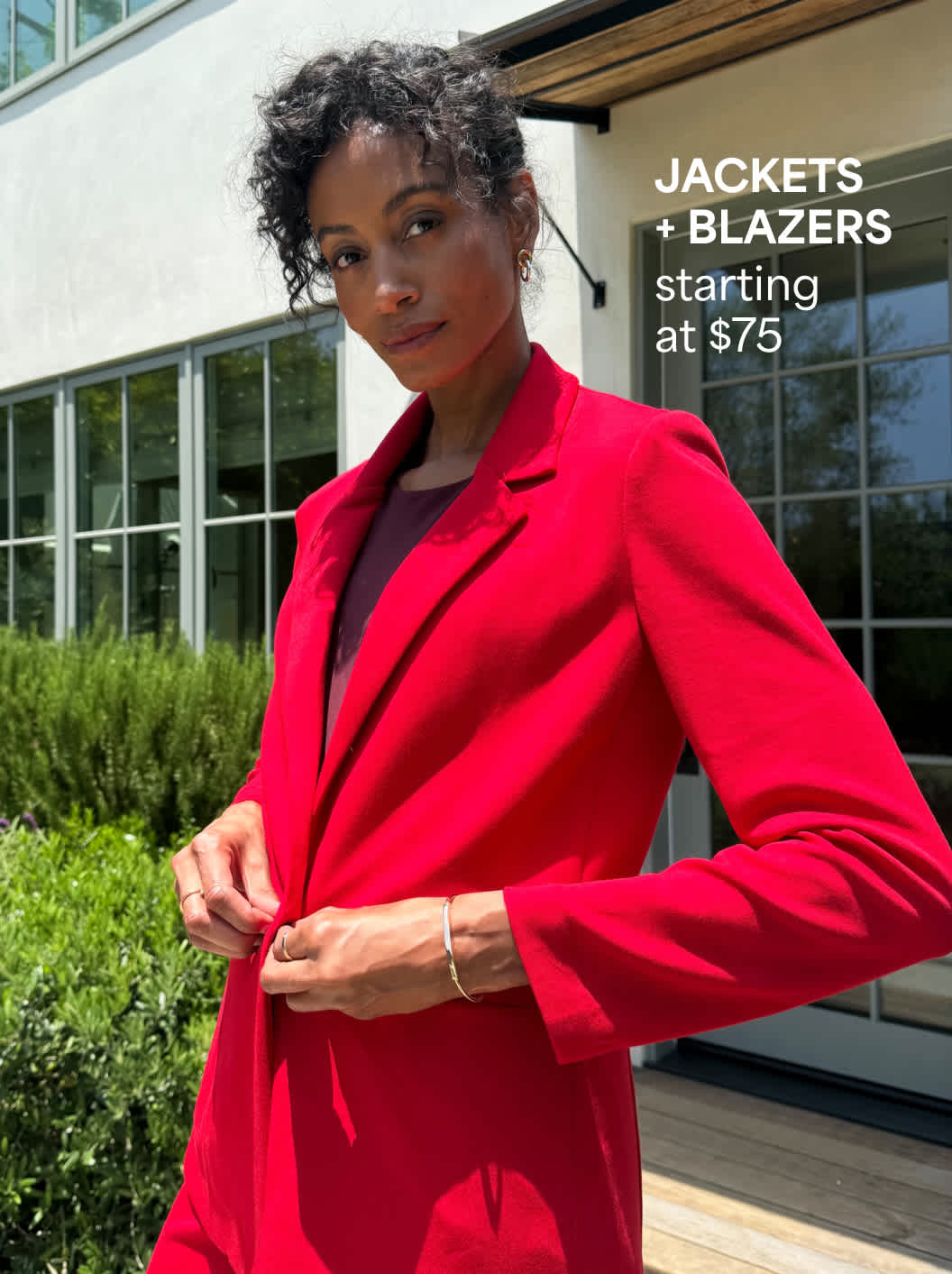 A Stitch Fix woman model posing and wearing a bright-red blazer. Jackets + Blazers starting at $75