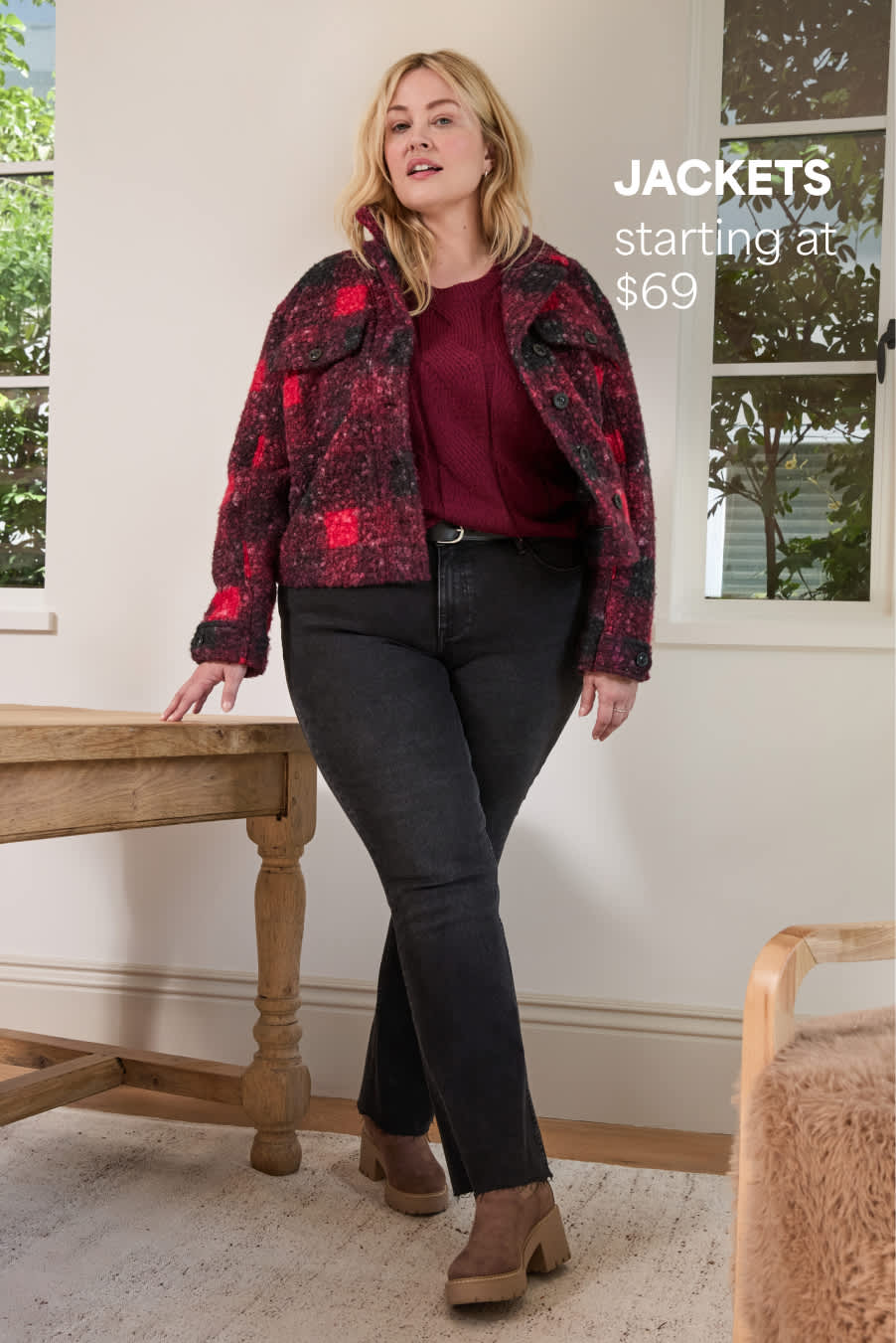 Stitch Fix women’s image showing a woman in a red-and-black plaid sherpa jacket with dark jeans, standing by a window. Text reads: “Jackets starting at $69.”