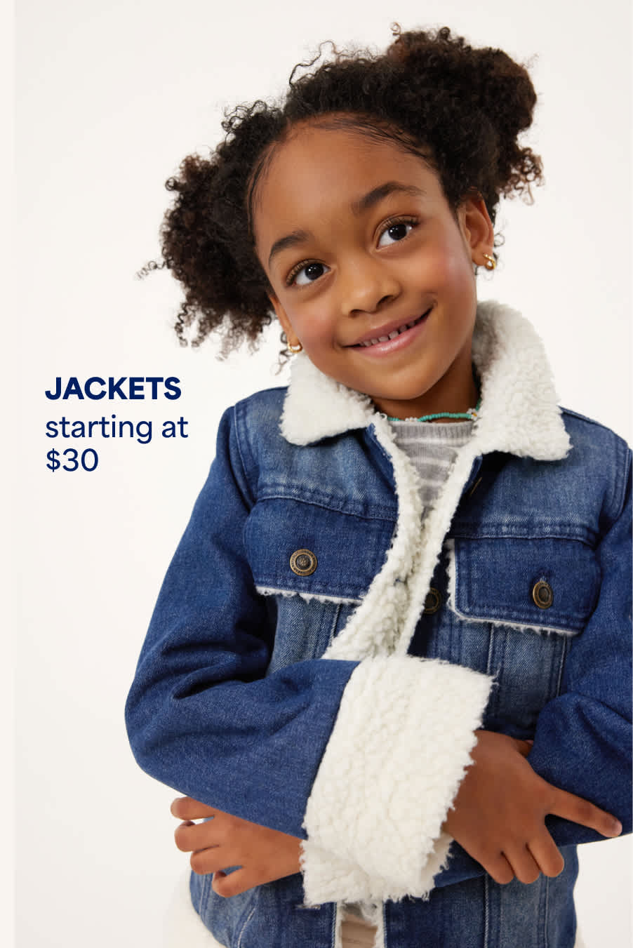 Stitch Fix young girl model smiling and wearing a striped sweater and fur-lined denim jacket. Text overlay on image reads “Jackets starting at $30”