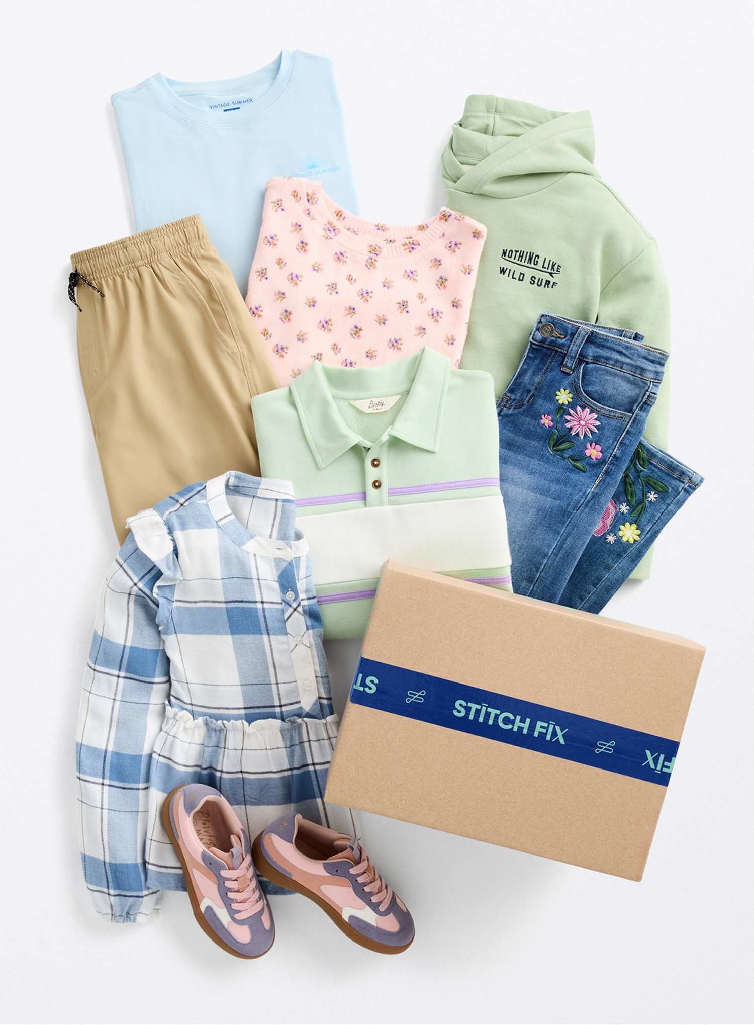 A woman takes a mirror selfie in a bedroom, wearing a beige trench coat layered over a striped shirt, light-colored wide-leg pants, and neutral sneakers. An inset image shows the same trench coat on its own, with thumbs-up and thumbs-down icons suggesting outfit feedback. Text on the image reads “Styled by Alero,” alongside a small circular headshot of the stylist, highlighting a personalized styling recommendation.