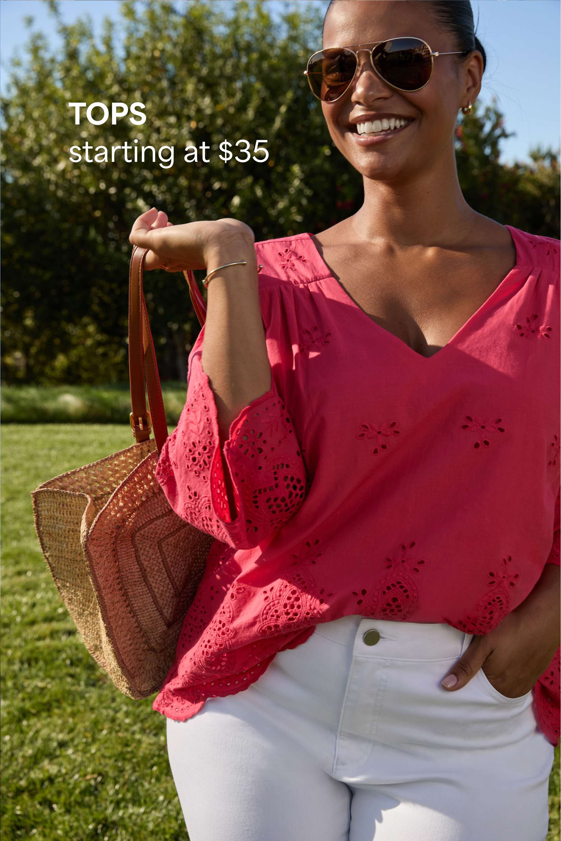 A woman Stitch Fix model poses in a grassy field in a pink blouse. A text overlay reads: “TOPS - starting at $35”.
