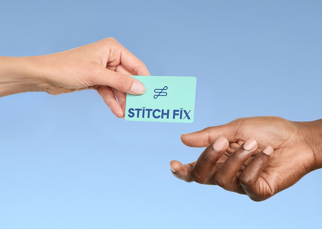 A hand holding a Stitch Fix gift card