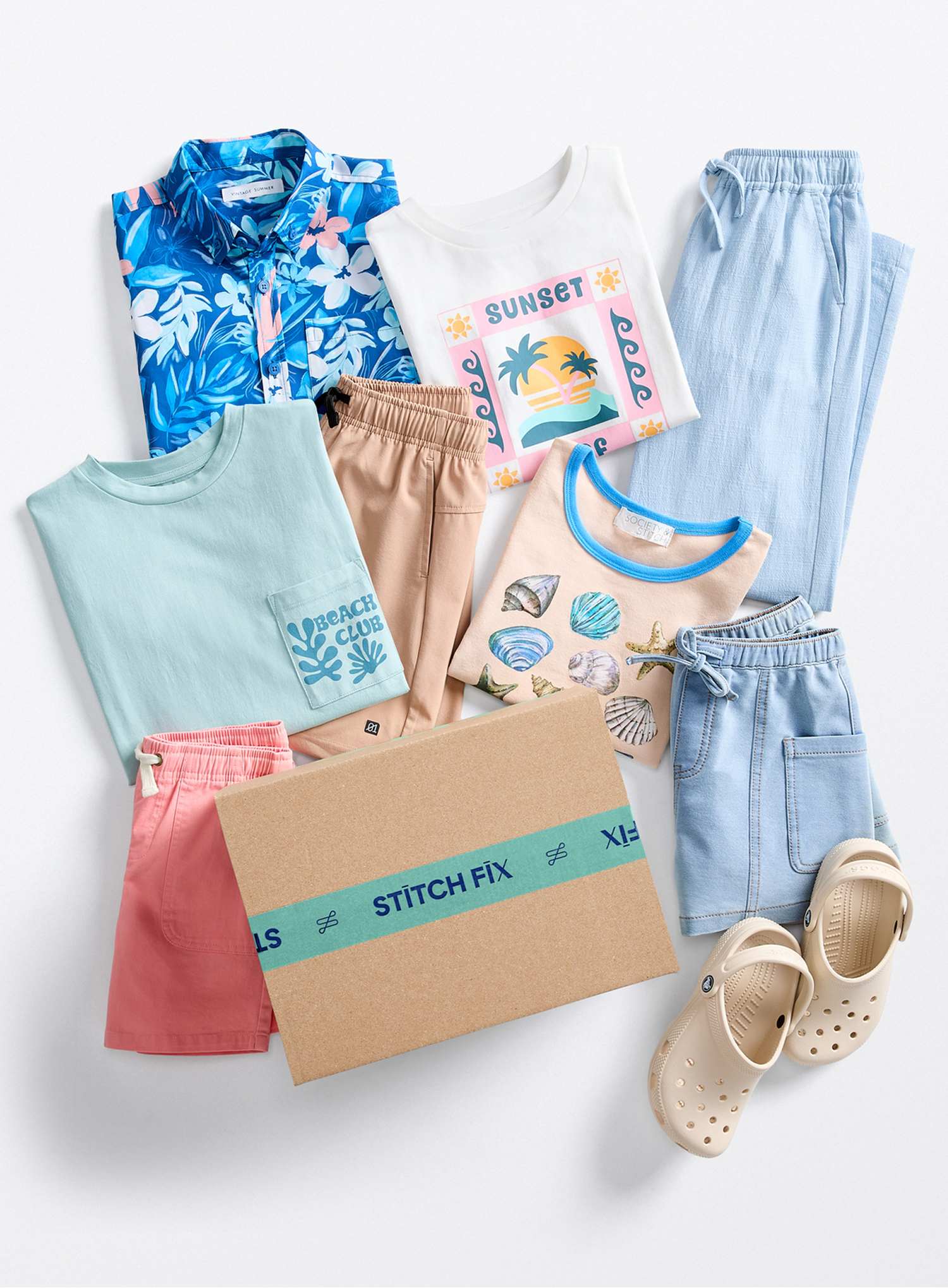 A styled kids’ flat lay featuring colorful casual separates including graphic tees, tropical and shell prints, lightweight joggers, shorts, sandals, and a Stitch Fix box in bright summer colors.