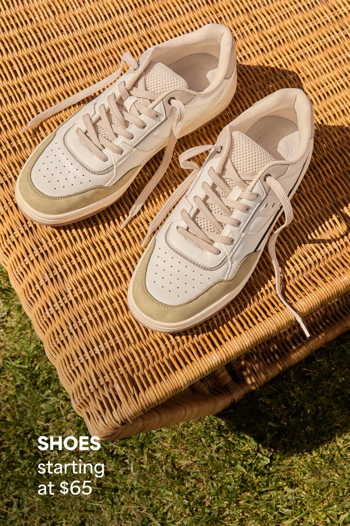 A pair of neutral sneakers displayed on a woven surface beside text that reads “SHOES starting at $65.”