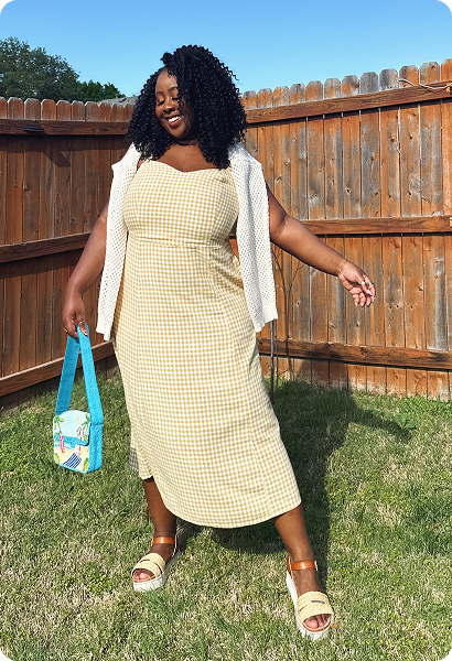 Jaimmy wearing a yellow dress outside