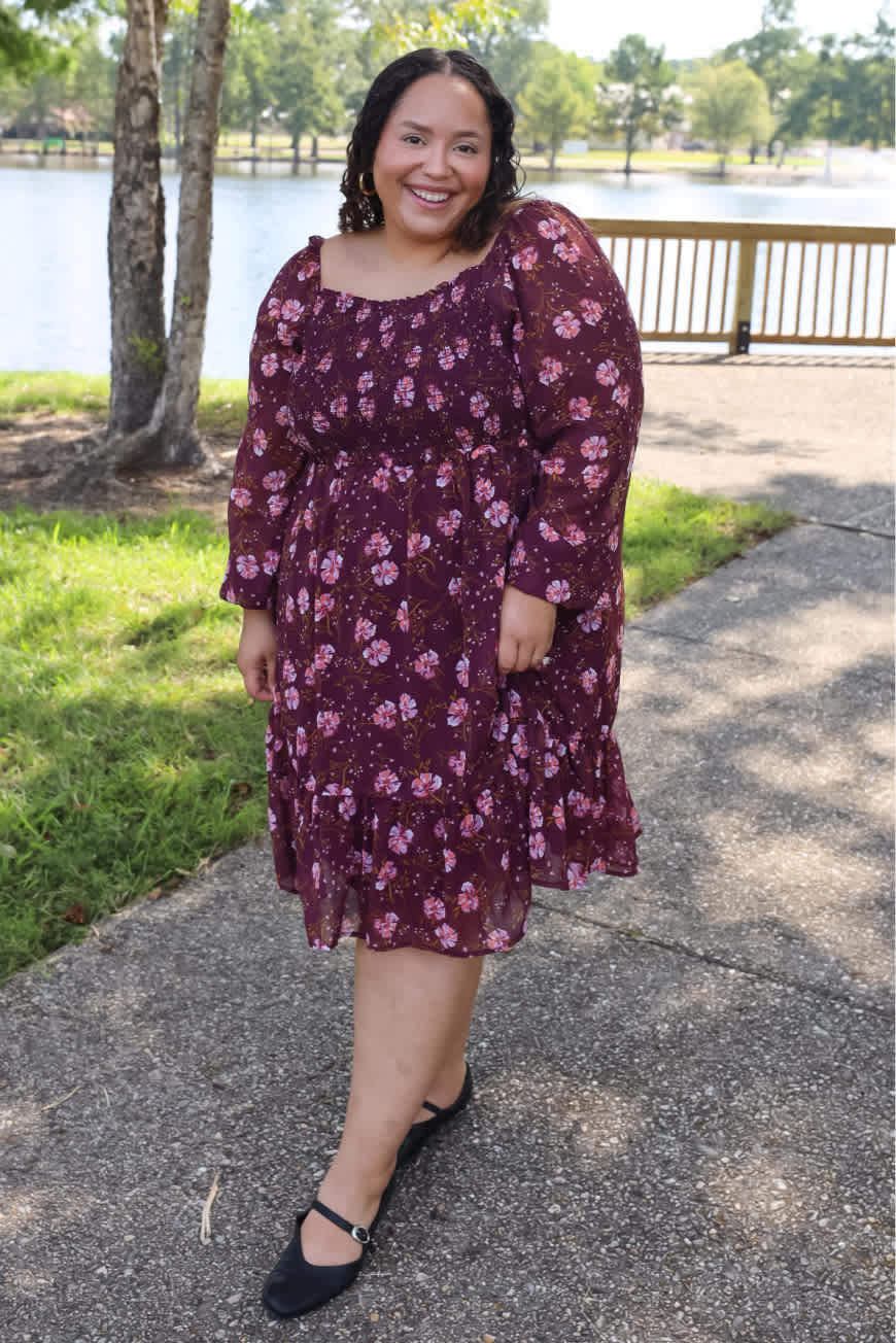 Model wearing Stitch Fix women’s clothing including matcha green sweater and silk skirt with beige trench.