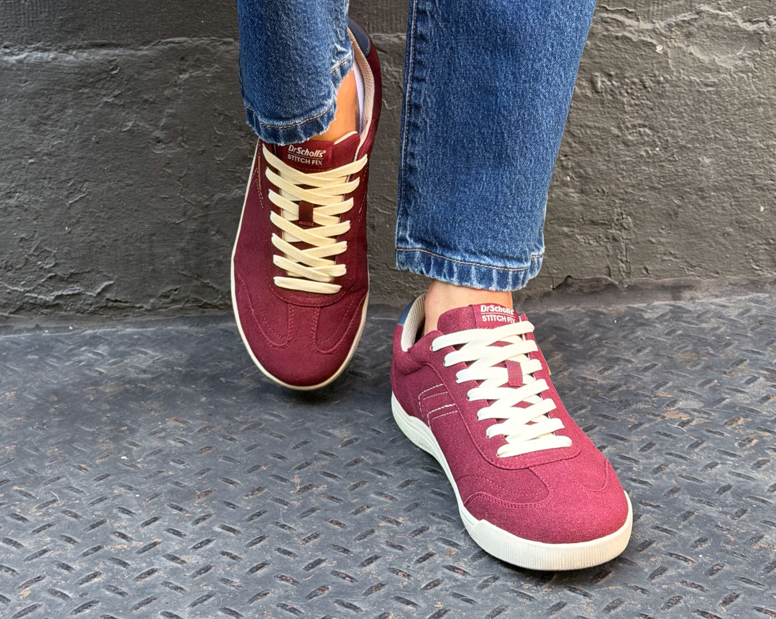 Close-up of burgundy Dr. Scholl's x Stitch Fix sneakers paired with cuffed blue jeans, showcasing the suede texture, cream laces, and casual everyday styling.