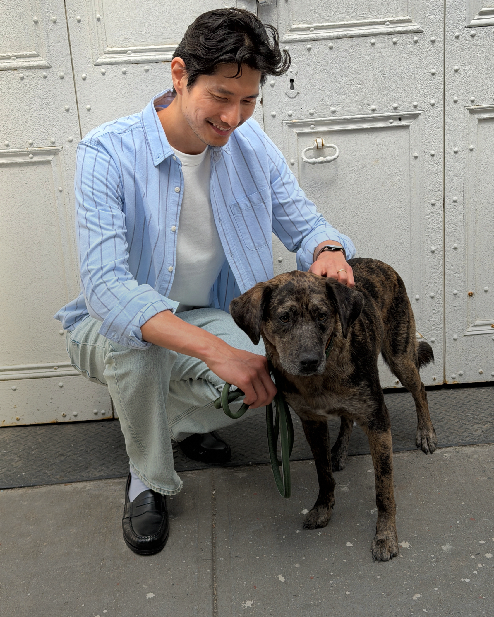 Side-by-side of a man in light blue striped shirt with arms crossed and a couple walking a dog in casual clothes