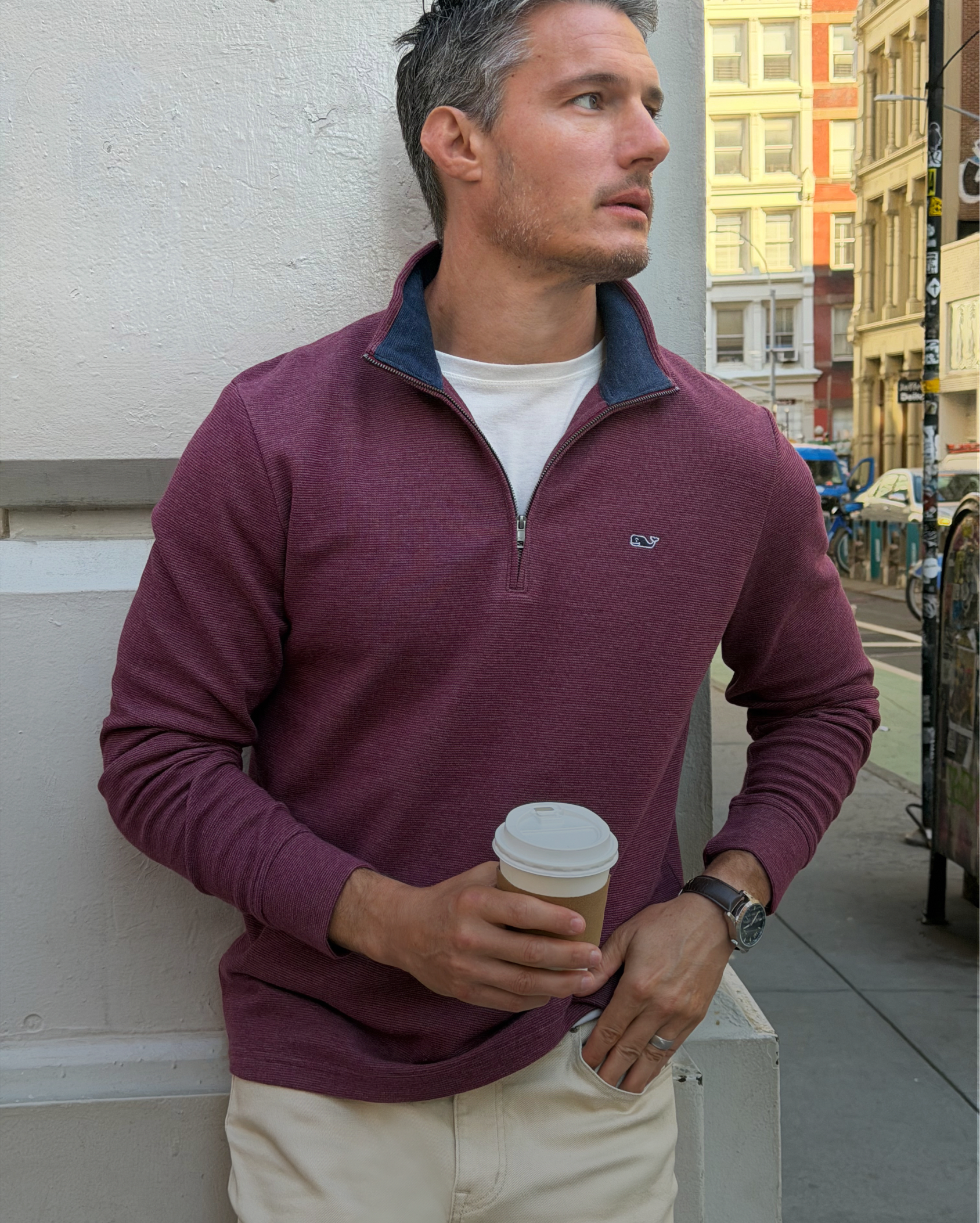 Side-by-side of a man in denim jacket with brown pants and a man sitting in burgundy quarter-zip sweater with khakis