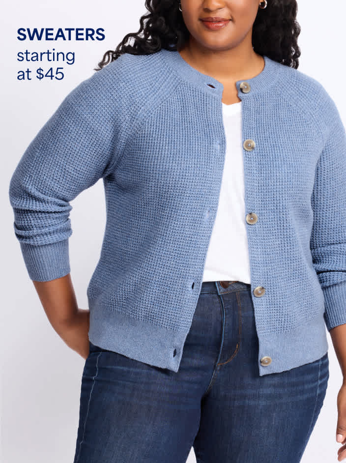 Woman wearing blue waffle knit cardigan sweater over white top and dark blue denim jeans. Sweaters starting at $45