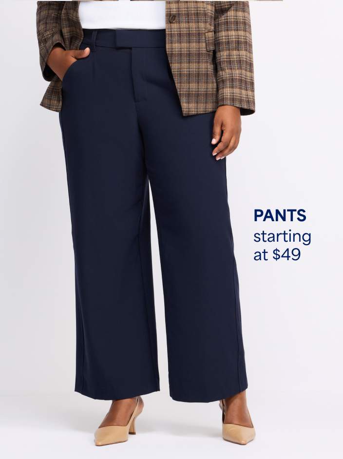 Woman wearing dark navy wide-leg trousers, beige slingback heels, and brown plaid blazer jacket. Pants starting at $49