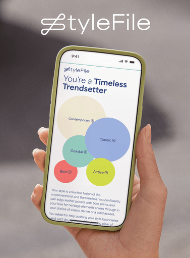 Hand holding phone with Stitch Fix’s personalized StyleFile feature on it.