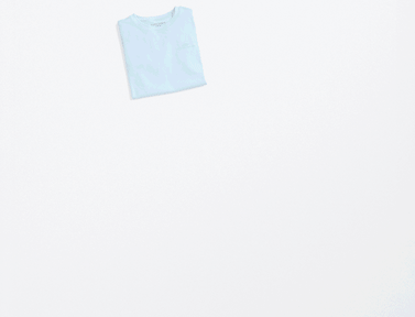 Stitch Fix box opened with folded kids’ clothes coming out of it. Featured items include: a blue graphic sweatshirt, gray jogger pants, sherpa jacket, a mint matching lounge set, a graphic sweater and fuzzy tan slippers.