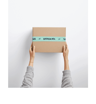 Model holding Stitch Fix subscription box.