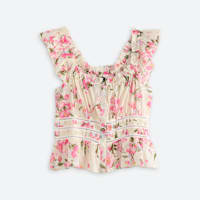 Women's sleeveless white top with ruffles and pink flowers