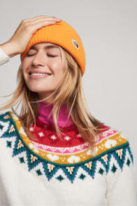 Model in Stitch Fix women’s clothing including an orange beanie and a fairisle sweater.