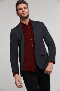 Model in Stitch Fix men’s clothing including a charcoal sport coat and maroon button-up shirt.