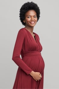 Model in Stitch Fix women’s maternity clothing including a maroon wrap dress.