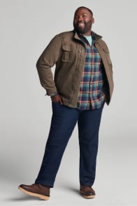 Model in Stitch Fix men’s clothing including a brown jacket, plaid shirt and jeans.