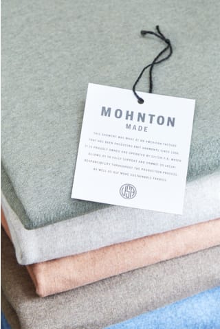 Stack of Stitch Fix Mohnton Made clothing with hang tag.