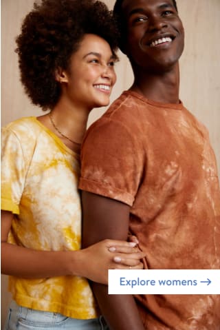 Models wearing Stitch Fix women’s and men’s Mohnton Made Earth Day cloud wash tees in fustic yellow and cutch brown.
